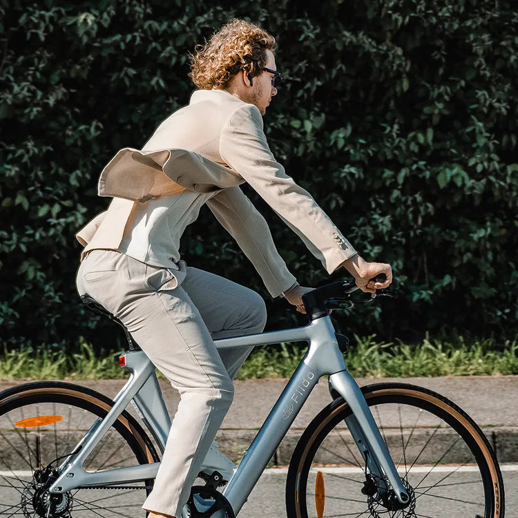 Rider using a pale silver Fiido Air carbon electric bike