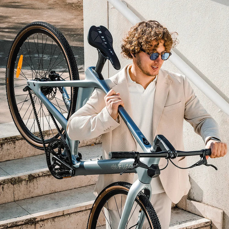 Lightweight Fiido Air carbon electric bike being carried up stairs