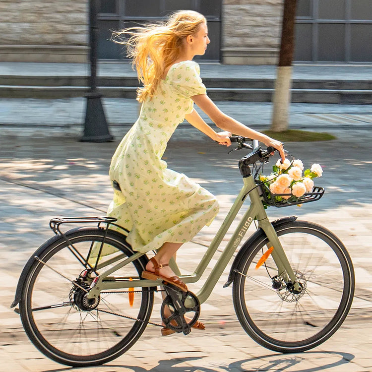 Rider commuting through the city on a green Fiido C700 electric bike