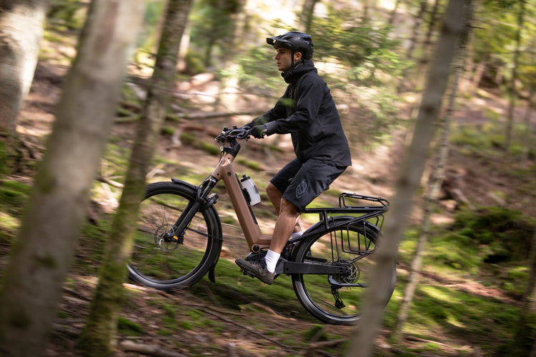 Moustache Xroad FS full-suspension electric bike being ridden on a woodland trail