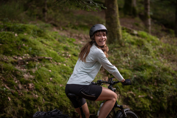 Rider enjoying a Moustache Xroad FS electric bike in woodland