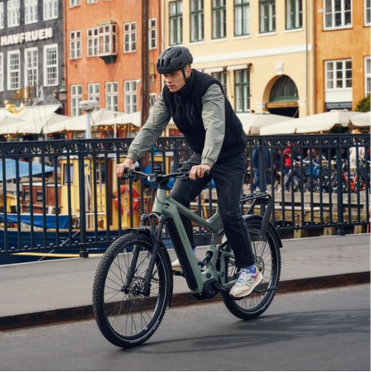 Riese & Müller Delite4 GT Touring full-suspension electric bike being ridden in the city